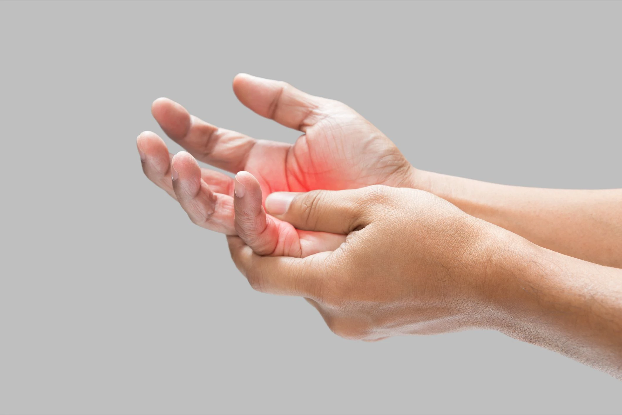 Hands holding palm with red pain highlight.