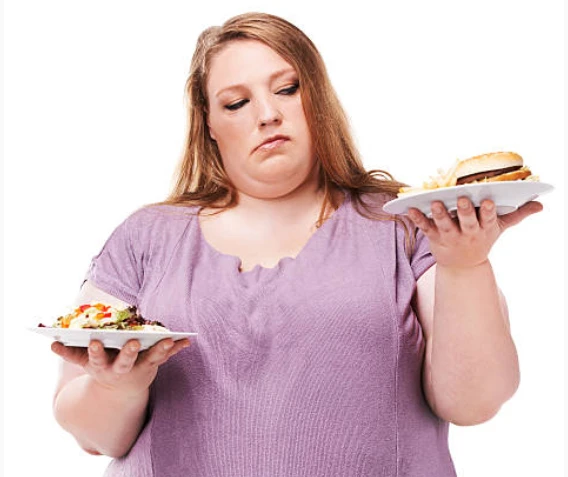 Person weighs salad vs. burger and fries, looking unsure.