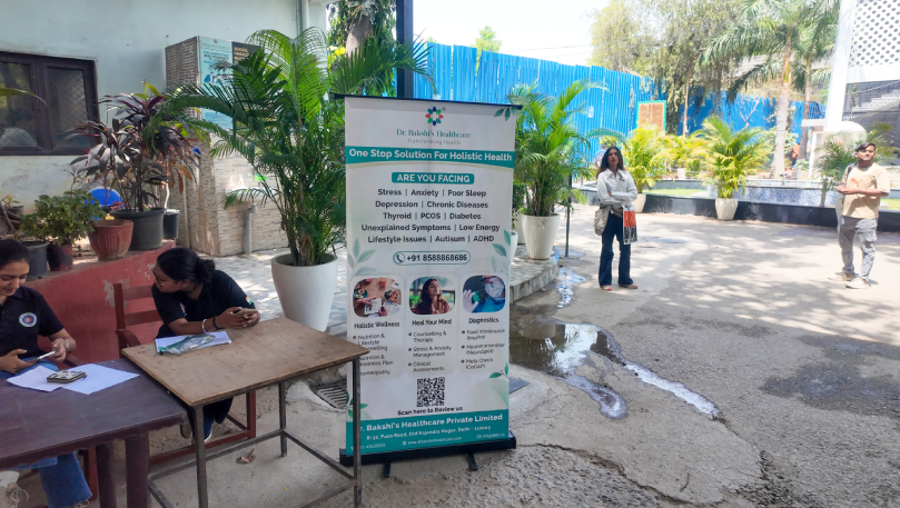 Dr. Bakshi's Healthcare banner at outdoor event.