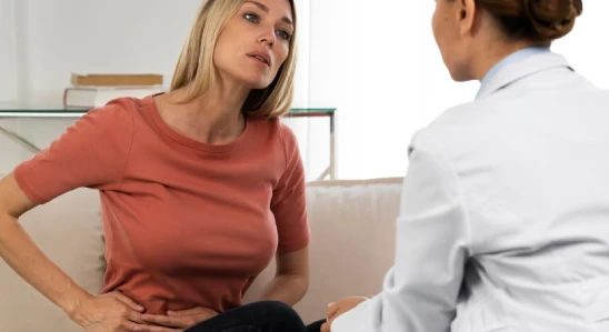 Woman in pain talking to doctor during consultation