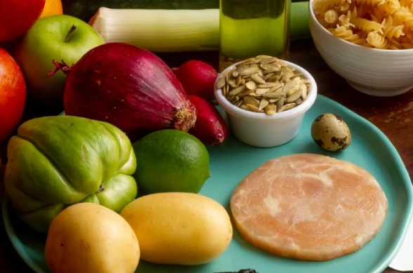 Plate with mixed foods like vegetables, meat, fruit, and grains