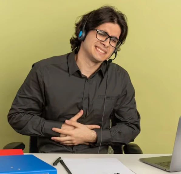 Office worker clutching stomach in pain